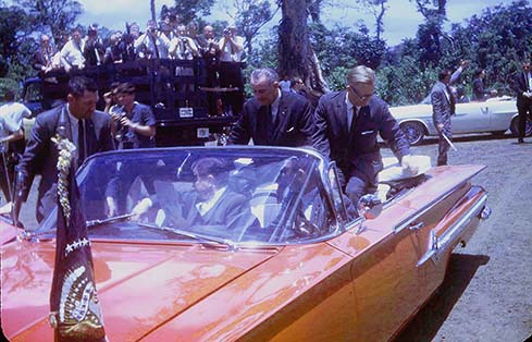 The motorcade heads toward the school dedication.