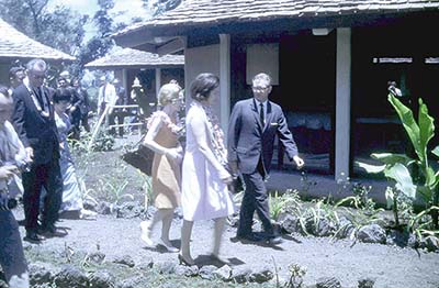 Lady Bird is dressed appropriately for the heat, while her husband the President wears a wool suit.